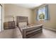 Bedroom with neutral walls, carpet, a lamp, and a bright window with a view at 13262 Elizabeth St, Thornton, CO 80241