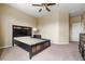 Bright bedroom features neutral walls, carpet, and a ceiling fan at 13262 Elizabeth St, Thornton, CO 80241