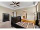 Bright bedroom features neutral walls, carpet, ceiling fan, and doorway to bathroom at 13262 Elizabeth St, Thornton, CO 80241