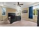 Bright bedroom features neutral walls, carpet, ceiling fan, and large window providing ample natural light at 13262 Elizabeth St, Thornton, CO 80241