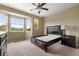 Bright bedroom features neutral walls, carpet, and multiple windows providing ample natural light at 13262 Elizabeth St, Thornton, CO 80241