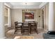 Dining room with a rustic table set, chandelier, and neutral walls, perfect for entertaining at 13262 Elizabeth St, Thornton, CO 80241