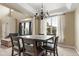 Dining room featuring a chandelier and a square wood table with seating for a gathering at 13262 Elizabeth St, Thornton, CO 80241