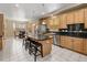 Open kitchen featuring an island with bar seating and stainless steel appliances at 13262 Elizabeth St, Thornton, CO 80241