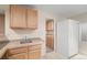 The kitchenette has wood cabinets and countertops, with a refrigerator at 13262 Elizabeth St, Thornton, CO 80241