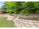 Picturesque landscaping with terraced retaining walls and lush greenery enhances the backyard at 13262 Elizabeth St, Thornton, CO 80241