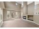 Open living room with a fireplace, high ceilings, and large windows that flood the space with natural light at 13262 Elizabeth St, Thornton, CO 80241
