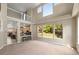 Open-concept view of the living room and kitchen, highlighting the high ceilings and bar seating at 13262 Elizabeth St, Thornton, CO 80241