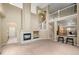 Spacious open-concept space featuring a fireplace and high ceilings, connecting living and dining areas at 13262 Elizabeth St, Thornton, CO 80241