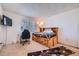 Bedroom with wood-frame bed, desk, and a small mounted television at 1864 S Pitkin Cir # B, Aurora, CO 80017