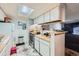 Kitchen with white cabinets, a skylight, and an open layout to the dining area at 1864 S Pitkin Cir # B, Aurora, CO 80017