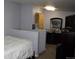 Cozy bedroom with dresser, television, mirrored furnishings, partition and neutral colors at 2356 S Franklin St, Denver, CO 80210