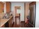 Galley kitchen with stainless steel appliances and wooden cabinets at 2356 S Franklin St, Denver, CO 80210