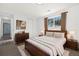 Fully furnished bedroom featuring a wooden bed frame, a dresser and a window with view of trees at 5193 Zinnia St, Arvada, CO 80002