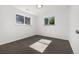 This is a cozy bedroom with two windows allowing natural light to illuminate the carpeted floor at 5193 Zinnia St, Arvada, CO 80002