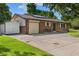 Charming brick home featuring mature trees, a spacious driveway, and a convenient attached one car garage at 5193 Zinnia St, Arvada, CO 80002