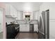 Updated kitchen featuring stainless steel appliances, sleek cabinetry, and a modern design at 5193 Zinnia St, Arvada, CO 80002