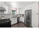 Modern kitchen with white cabinets, stainless steel appliances, and ample counter space at 5193 Zinnia St, Arvada, CO 80002