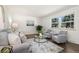 Sunlit living room showcasing hardwood floors, modern decor, and a comfortable seating arrangement at 5193 Zinnia St, Arvada, CO 80002
