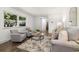 Light-filled living room with hardwood floors, stylish furnishings, and a bright, open feel at 5193 Zinnia St, Arvada, CO 80002