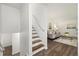Inviting foyer with wood floors, staircase, and a glimpse into the cozy living room at 5193 Zinnia St, Arvada, CO 80002