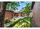 Private backyard oasis with patio, lush lawn, and mature trees, providing a serene outdoor retreat at 5401 E Dakota Ave # 22, Denver, CO 80246
