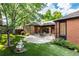 Landscaped backyard featuring patio, manicured lawn, and mature trees, ideal for outdoor living and enjoyment at 5401 E Dakota Ave # 22, Denver, CO 80246