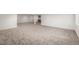 View of the finished basement showcasing plush gray carpeting, and a modern wet bar at 5401 E Dakota Ave # 22, Denver, CO 80246