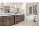 Beautiful bathroom with dual sink vanity, standalone tub, and bright lighting at 5401 E Dakota Ave # 22, Denver, CO 80246