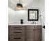 Stylish bathroom featuring a vessel sink, modern lighting fixture, and quartz counters at 5401 E Dakota Ave # 22, Denver, CO 80246