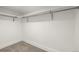 Walk-in closet with carpeted floors, white walls and metal hanging rods with supports at 5401 E Dakota Ave # 22, Denver, CO 80246
