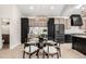Contemporary dining area showcasing a glass table, stylish seating, modern lighting, and cabinetry at 5401 E Dakota Ave # 22, Denver, CO 80246