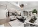 Spacious living room with open layout, leading to a modern kitchen and outdoor patio through sliding glass doors at 5401 E Dakota Ave # 22, Denver, CO 80246