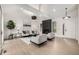 Bright and modern living room boasts vaulted ceilings, statement lighting, sleek fireplace, and comfortable seating at 5401 E Dakota Ave # 22, Denver, CO 80246