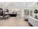 Open-concept living area seamlessly connects kitchen, dining, and lounge areas, accentuated by natural light and modern design at 5401 E Dakota Ave # 22, Denver, CO 80246