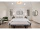 Bright main bedroom with light hardwood floors, a bench, and contemporary decor at 5401 E Dakota Ave # 22, Denver, CO 80246