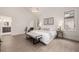 Bright main bedroom with light hardwood floors, a bench, and views to the bathroom at 5401 E Dakota Ave # 22, Denver, CO 80246