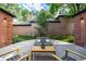 Outdoor patio seating area with fountain feature surrounded by brick exterior and lush landscaping at 5401 E Dakota Ave # 22, Denver, CO 80246