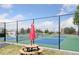 Community pickleball courts with green and blue surfacing, black chainlink fence, and umbrella-shaded picnic table at 839 Diamond Ridge Cir, Castle Rock, CO 80108