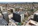 Aerial view of a multi-story apartment building surrounded by downtown city views at 909 N Logan St # 11A, Denver, CO 80203