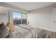 Bright bedroom with hardwood floors and balcony access for city views at 909 N Logan St # 11A, Denver, CO 80203