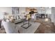 Living room with gray sofa, decorative pillows, area rug, and an open floor plan to the kitchen at 909 N Logan St # 11A, Denver, CO 80203