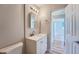 Updated bathroom with a vanity and access to another room at 1289 Newark St, Aurora, CO 80010