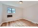 Charming bedroom with hardwood floors and a window at 1289 Newark St, Aurora, CO 80010