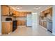 Bright kitchen featuring ample wood cabinets, and modern appliances at 1289 Newark St, Aurora, CO 80010