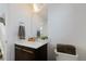 Modern half bath with dark wood vanity, white countertop, and sleek fixtures at 9624 Dunning Cir, Highlands Ranch, CO 80126