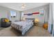 Bright bedroom with large bed, neutral walls and cozy chair near the window at 9624 Dunning Cir, Highlands Ranch, CO 80126