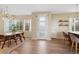 Inviting dining area featuring a modern chandelier, stylish table with seating, and large windows at 9624 Dunning Cir, Highlands Ranch, CO 80126