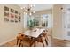 Bright dining area featuring a modern chandelier, stylish table with seating, and large windows at 9624 Dunning Cir, Highlands Ranch, CO 80126