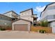 Exterior view of a home with a two-car garage and upstairs balcony at 9624 Dunning Cir, Highlands Ranch, CO 80126